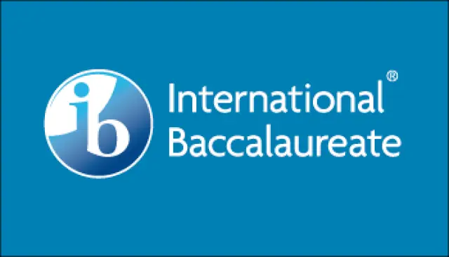 International Baccalaureate logo on a blue background, featuring a white lowercase ib inside a blue circle, with the words International Baccalaureate in white text to the right, often seen in news media and media coverage.