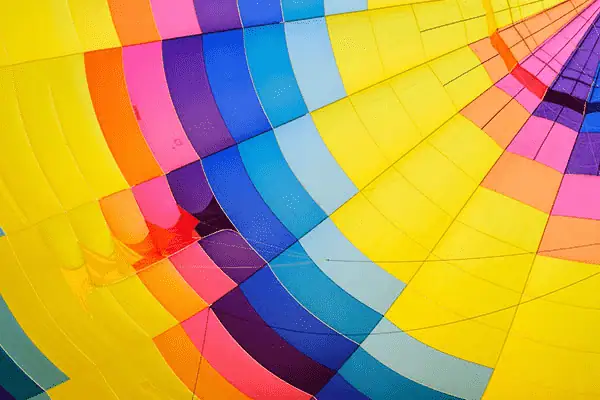 Rainbow hot air balloon fabric, vibrant colors, geometric pattern for marketing visuals.